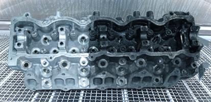 An image of a metal part with a complex shape and many blind holes being prepared for precision parts cleaning.