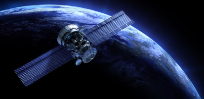 Satellite orbiting Earth with solar panels extended, illuminated by sunlight against the dark backdrop of space.